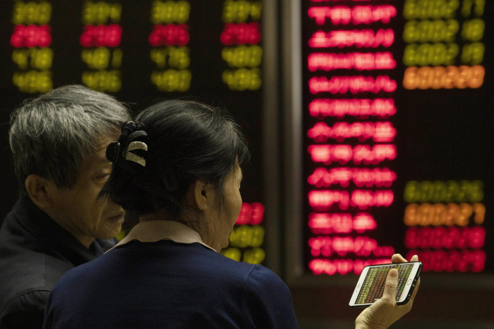 Investors monitor stock prices at a brokerage in Beijing on Thursday, Dec. 12, 2019. Asian shares are mixed after a wobbly day on Wall Street following the Federal Reserve announcement that it would leave interest rates unchanged. Japan's benchmark Nikkei 225, South Korea's Kospi and Hong Kong's Hang Seng rose in early Thursday trading. (AP Photo/Ng Han Guan)