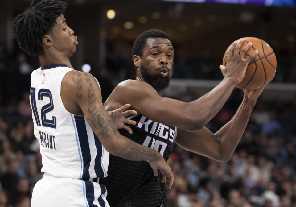 Sacramento Kings forward Harrison Barnes (40) looks to pass while defended by Memphis Grizzlies guard Ja Morant (12) during the first half of an NBA basketball game Friday, Feb. 28, 2020, in Memphis, Tenn. (AP Photo/Nikki Boertman)