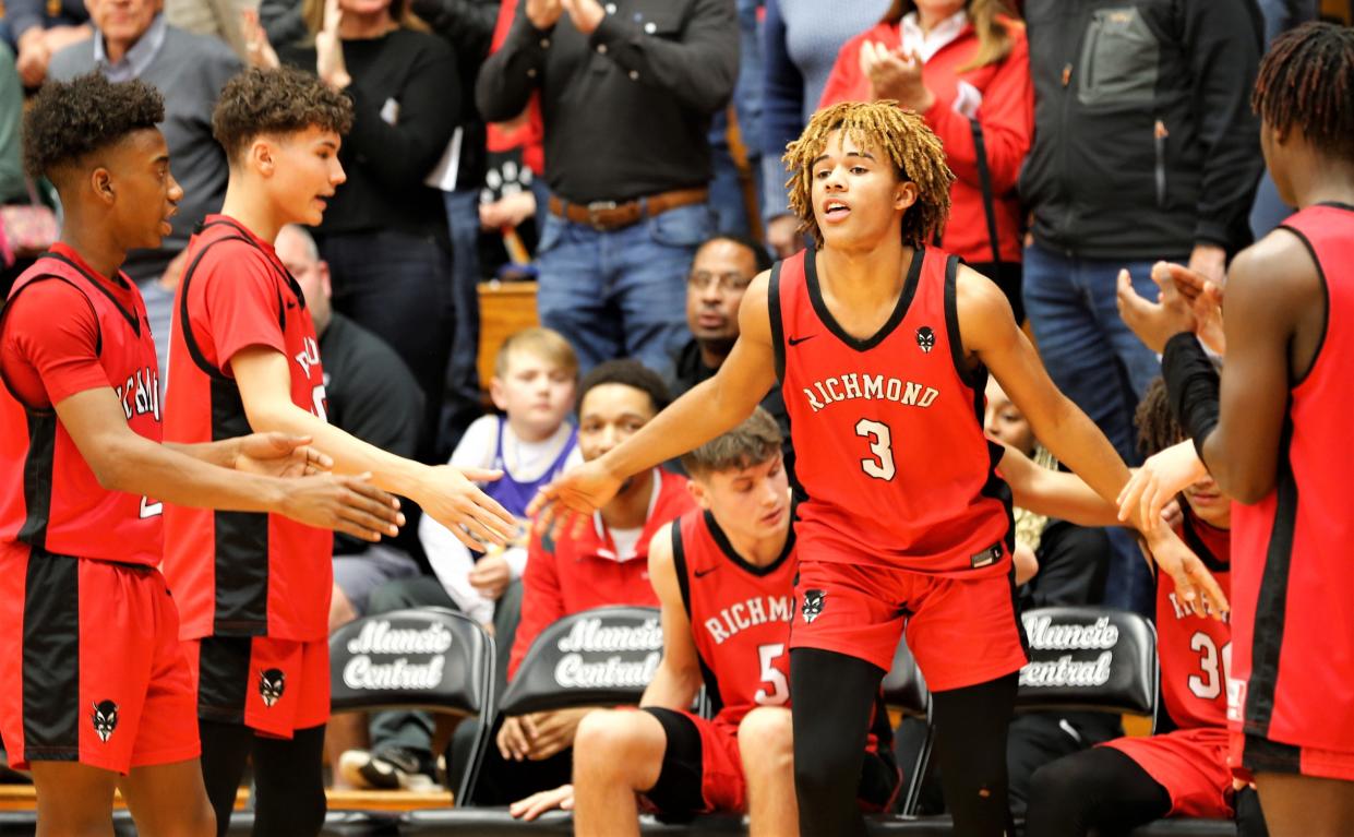 Richmond sophomore Mason Carpenter high-fives his teammates during starting lineup announcements before a sectional game against Pendleton Heights Feb. 28, 2023.