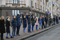 Belarusians take part in the "Living Chain" action in support of the country's independence in downtown Minsk, Belarus, Saturday, Dec. 7, 2019. Several hundreds demonstrators gathered to protest against closer integration with Russia. (AP Photo/Sergei Grits)