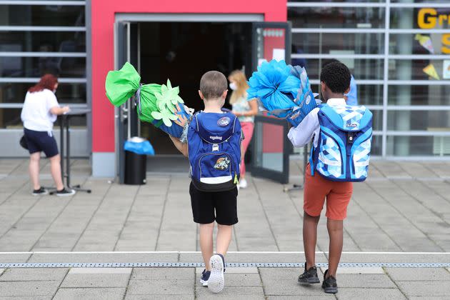 First graders arrive with their cones for their first day of school on Aug. 13, 2020, in Oberpleis, Germany.