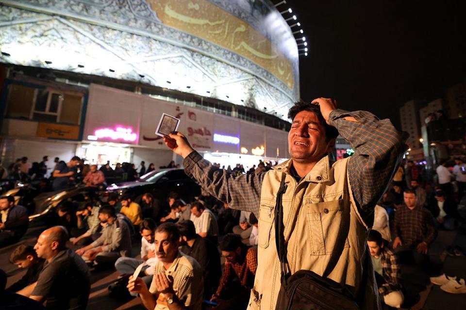 Iranians pray for President Ebrahim Raisi and Foreign Minister Hossein Amir-Abdollahian in Valiasr Square in central Tehran on May 19, 2024. A helicopter in the convoy Raisi and Amir-Abdollahian was involved in "an accident" in East Azerbaijan province in poor weather conditions on May 19, state television reported. (Photo by ATTA KENARE / AFP) (Photo by ATTA KENARE/AFP via Getty Images) ORIG FILE ID: 2153220026