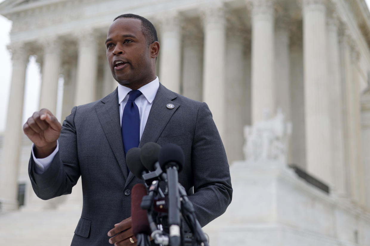 Attorney General Daniel Cameron at the microphone with the colonnades of the Supreme Court in the background.