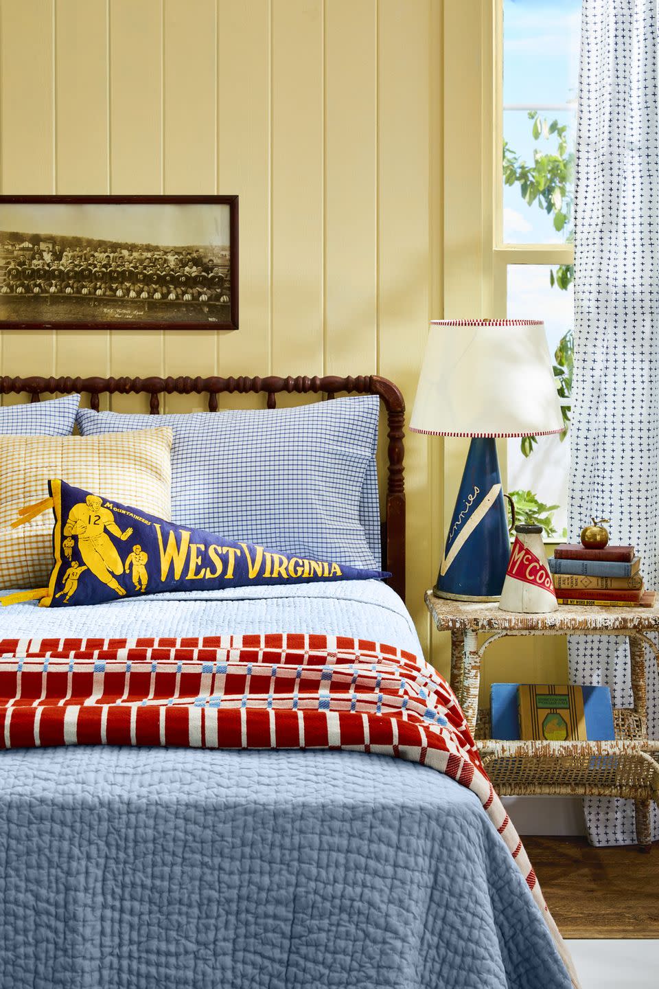 yellow bedroom with college memorabilia decor