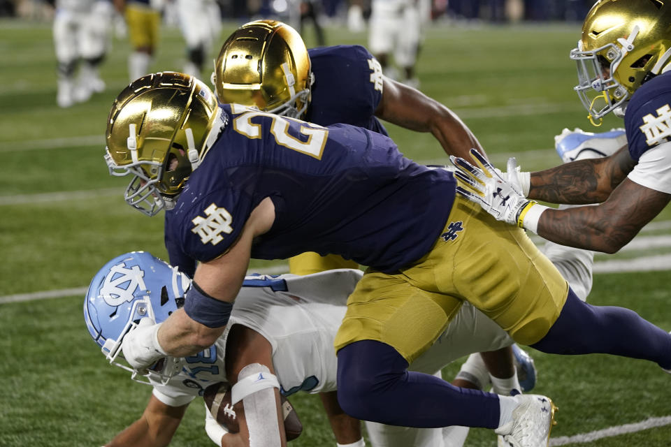 North Carolina tight end Bryson Nesbit is tackled by Notre Dame linebacker JD Bertrand (27) during the second half of an NCAA college football game, Saturday, Oct. 30, 2021, in South Bend, Ind. (AP Photo/Carlos Osorio)