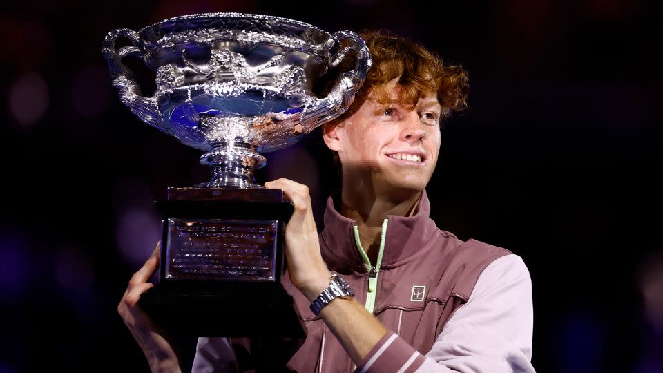 Jannik Sinner celebrates with the trophy after winning the Australian Open title. - Issei Kato/Reuters