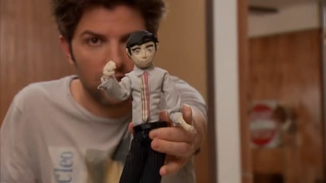 Ben holding a clay doll in "Parks and Recreation"