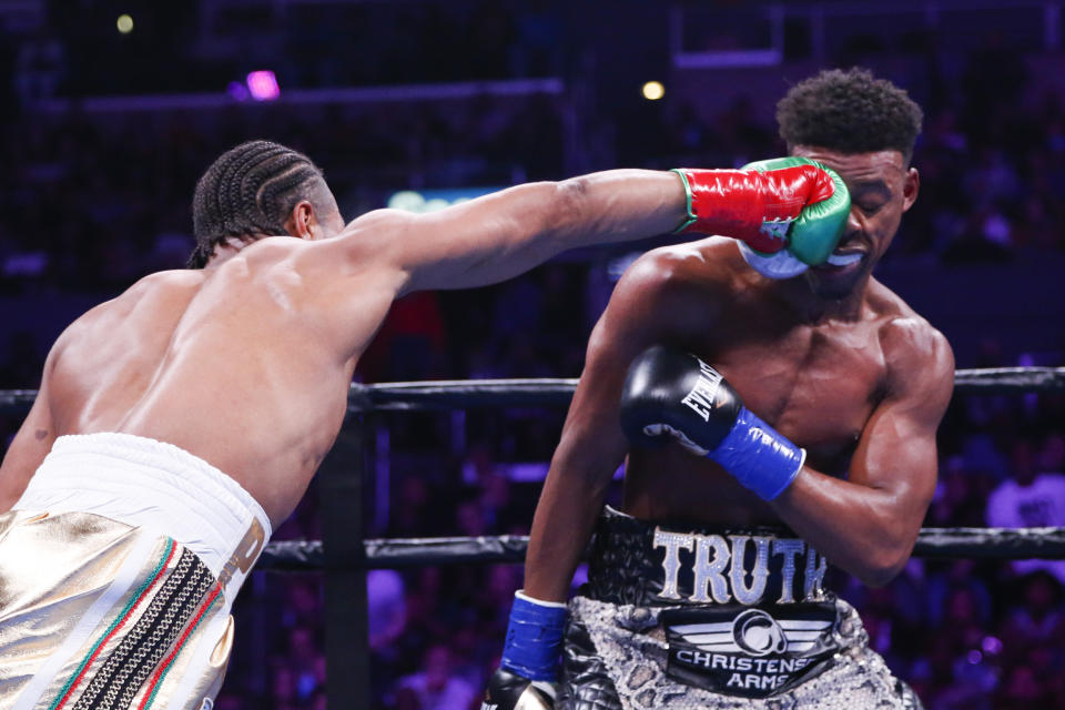Shawn Porter lands a punch to the face of Errol Spence Jr., during the WBC & IBF World Welterweight Championship boxing match Saturday, Sept. 28, 2019, in Los Angeles. (AP Photo/Ringo H.W. Chiu)