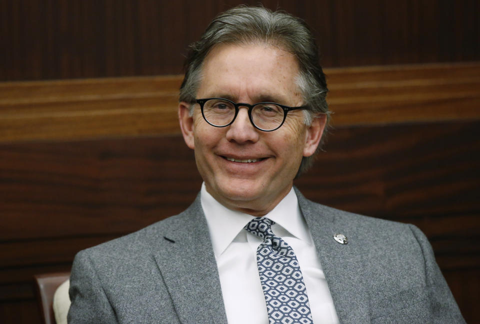 FILE - In this Feb. 1, 2019, file photo, is Oklahoma Attorney General Mike Hunter smiles during an interview in Oklahoma City. The Oklahoma Supreme Court has denied a request by drugmakers to postpone the trial in the state's lawsuit accusing them of fueling the opioid epidemic. The state's highest court handed down the decision Monday, a week after attorneys for drugmakers and the state made oral presentations on the request to delay the trial's scheduled May 28 start. Hunter sued 13 opioid manufacturers in 2017, alleging they fraudulently engaged in marketing campaigns that led to thousands of overdose addictions and deaths. Several states have filed similar lawsuits, but Oklahoma's is expected to be the first to go to trial. (AP Photo/Sue Ogrocki, File)