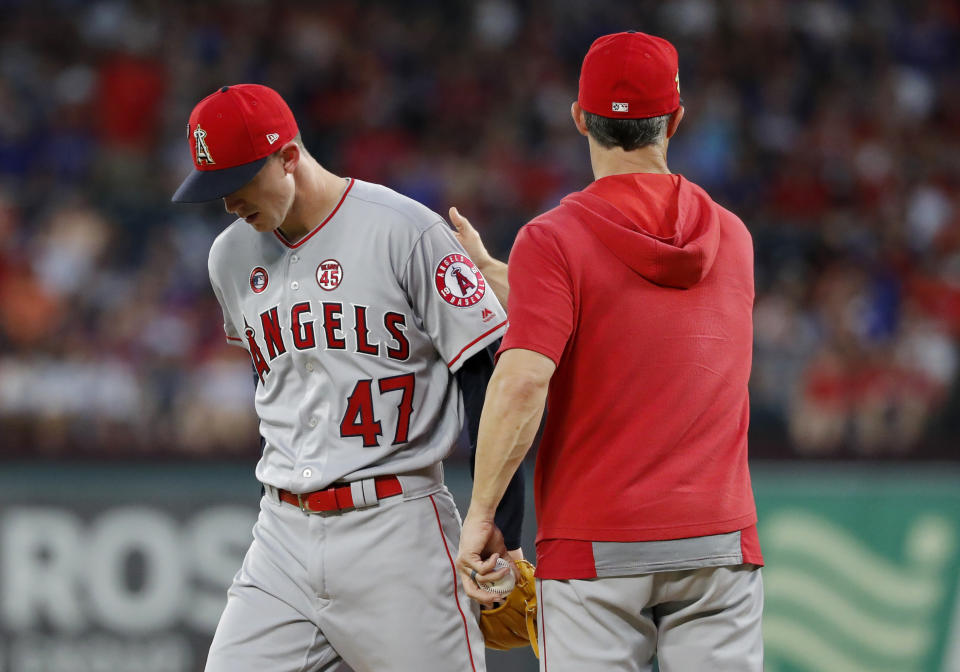 Los Angeles Angels' Griffin Canning (47) leaves the mound after turning the ball over to manager Brad Ausmus during the fourth inning of the team's baseball game against the Texas Rangers in Arlington, Texas, Thursday, July 4, 2019. (AP Photo/Tony Gutierrez)