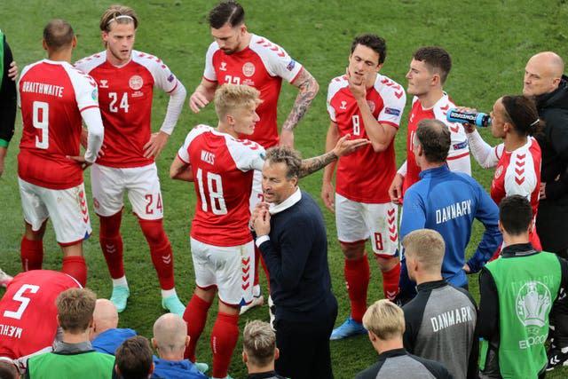 Denmark head coach Kasper Hjulmand talks to his squad on the pitch