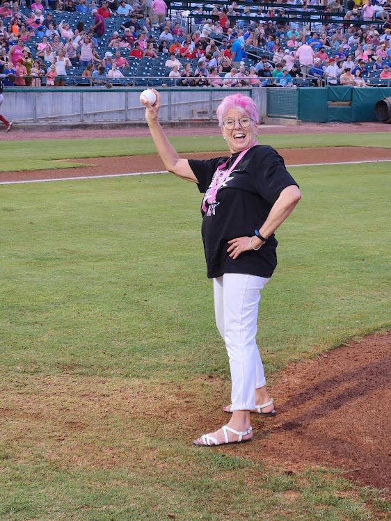 A beaming Mary Ann Venable displays her "First Pitch" souvenir baseball at Smokies Stadium on Aug. 5.