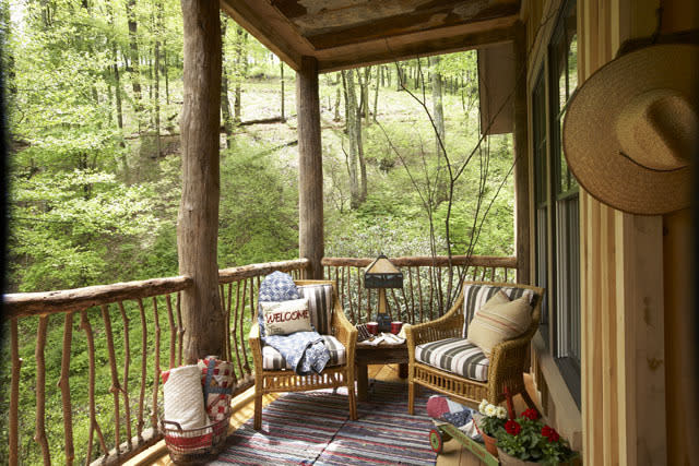 <p>Designed as a weekend retreat, the Whisper Creek cabin emphasizes a connection with nature. The wide, wrap-around porch offers ample space for chairs and a dining table. </p>