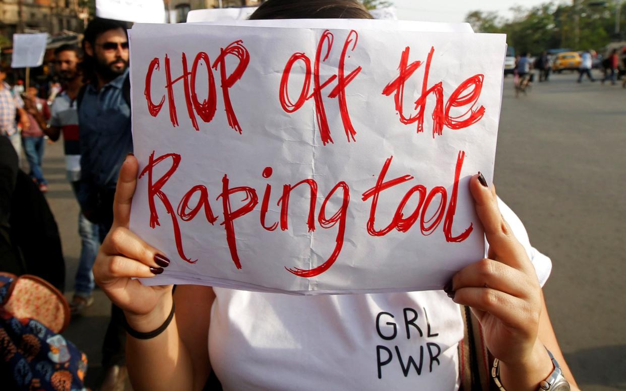 A woman holds a placard during a protest against the rape of an eight-year-old girl in Kathua near Jammu, and a teenager in Unnao, Uttar Pradesh state, in Kolkata, India, April 19, 2018. REUTERS/Rupak De Chowdhuri