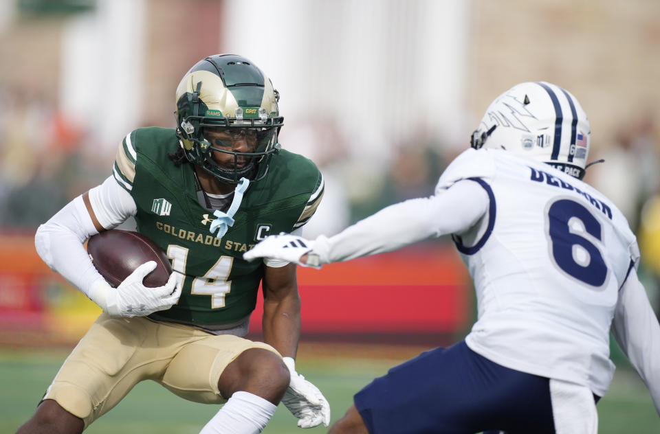 Colorado State wide receiver Tory Horton, left, looks for room to run after pulling in a pass in front of Nevada defensive back Jaden Dedman in the first half of an NCAA college football game Saturday, Nov. 18, 2023, in Fort Collins, Colo. (AP Photo/David Zalubowski)