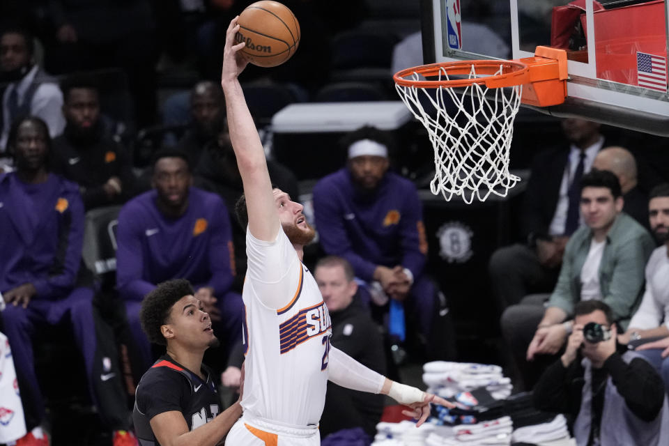 Phoenix Suns center Jusuf Nurkic (20) goes to the basket past Brooklyn Nets forward Cameron Johnson during the first half of an NBA basketball game, Wednesday, Jan. 31, 2024, in New York. (AP Photo/Mary Altaffer)