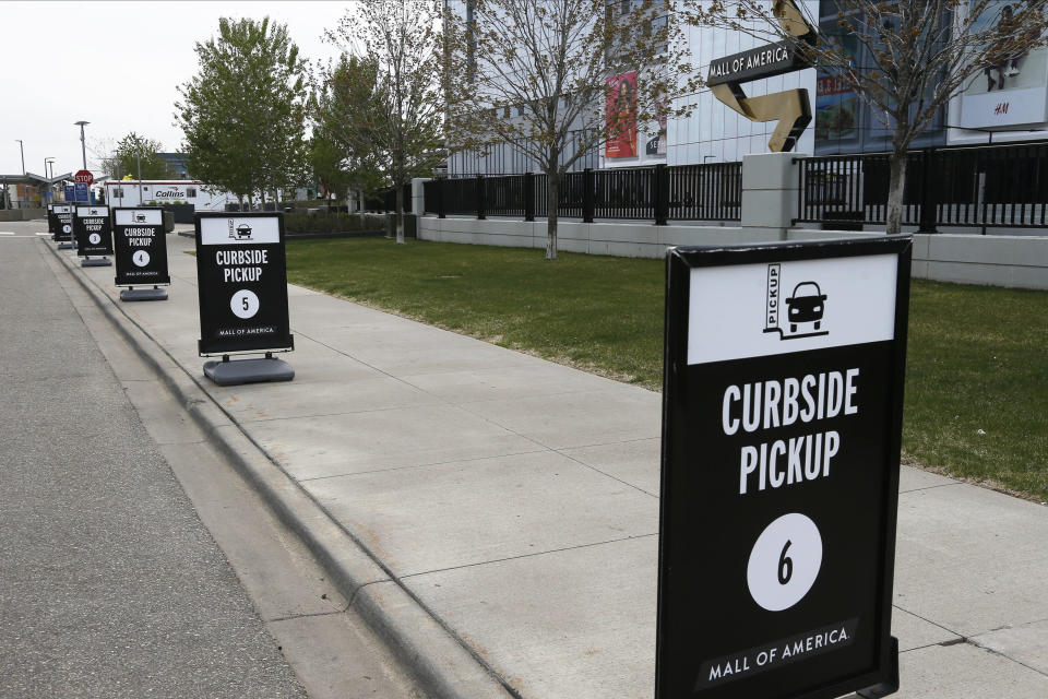 Curbside pickup spots are shown at the Mall of America for shoppers buying online or by phone from some mall stores Tuesday, May 5, 2020, in Bloomington, Minn. (AP Photo/Jim Mone)