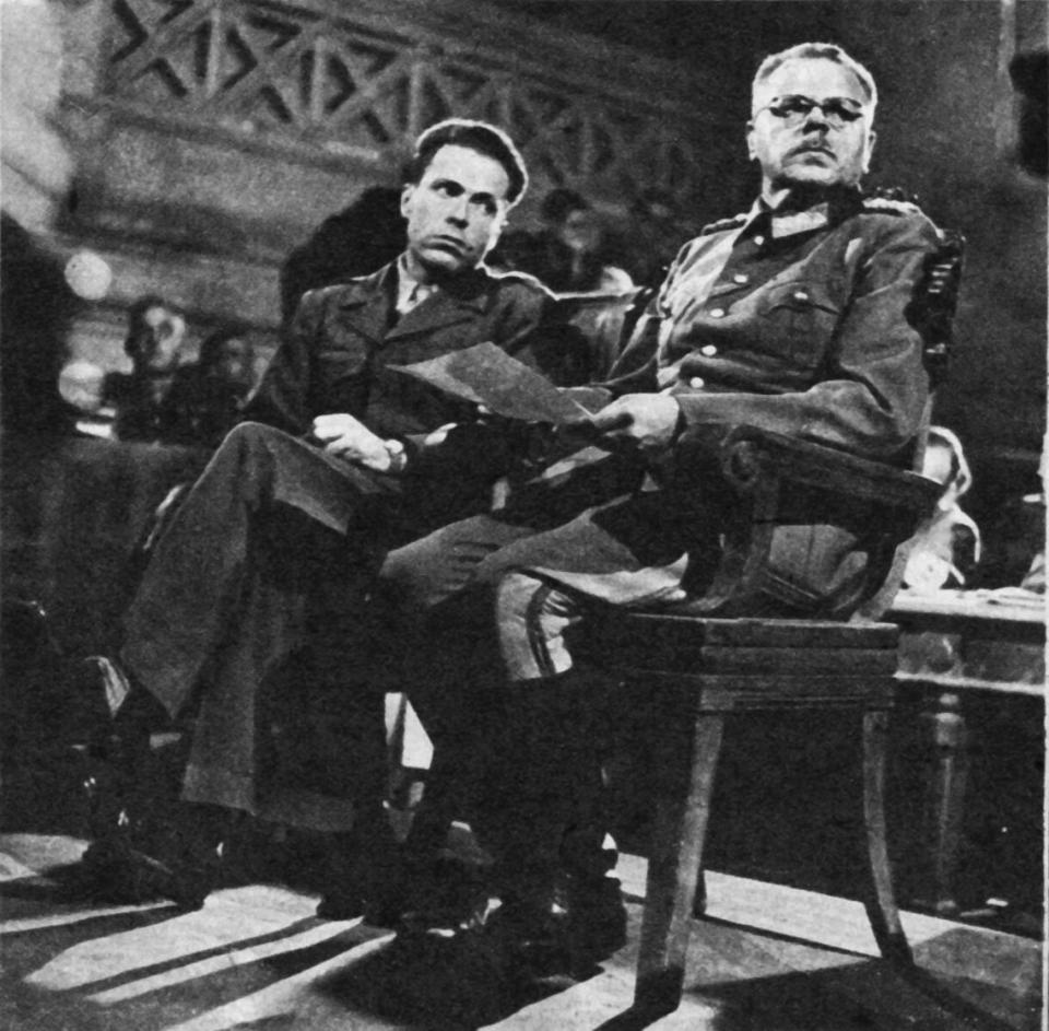 anton dostler on trial in 1945 at the palace of caserta in italy his interpreter is albert o hirschmann