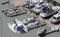 <p>A catamaran and sailboat are shown floundered in the wake of Hurricane Irma, Sept. 11, 2017, at a marina in Key Largo, Fla. (Photo: Wilfredo Lee/AP) </p>