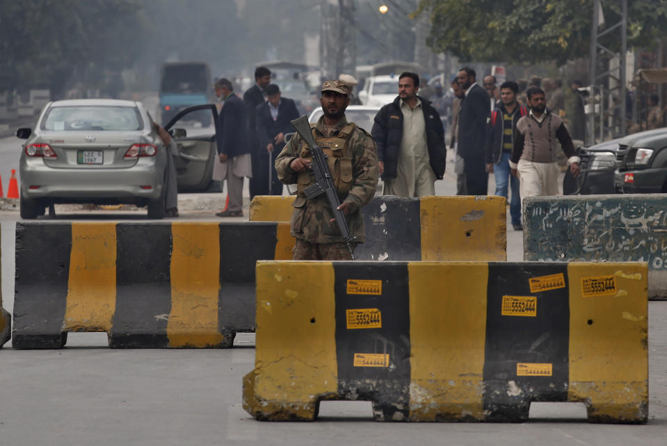 An army soldier stands at a checkpoint near Pindi Cricket stadium ahead of first test match between Pakistan and Sri Lankan cricket teams, in Rawalpindi, Pakistan, Monday, Dec. 9, 2019. Sri Lanka's cricket team arrived in Pakistan to play two-test series that will be the first tests in Pakistan in over a decade. Sri Lanka was the last team to play a test match in Pakistan in 2009 before the team came under terrorist attack at Lahore and the doors to international cricket were closed on Pakistan. (AP Photo/Anjum Naveed)