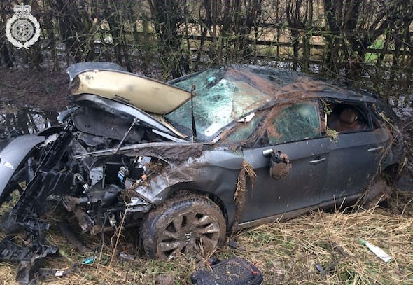 PIC BY WMAS / CATERS NEWS (PICTURED: THE CAR CRUSHED IN A DITCH IN WARWICKSHIRE) A driver who ended up in a ditch after his car flipped across the road has escaped with almost no injuries. The front of his car was destroyed in the collision that sent it flying across the A46 in Warwickshire SEE CATERS COPY