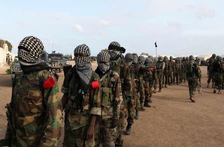 FILE PHOTO: Members of Somalia's al-Qaeda linked al Shabaab militia, parade after distributing relief to famine-stricken internally displaced people at Ala Yaasir camp at KM50 out of Mogadishu, Somalia September 3, 2011. REUTERS/Feisal Omar/File Photo