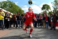 A Bayern Munich football trickster peforms outside Webley Stadium before the game.