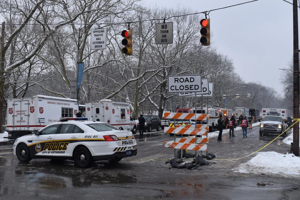 A Pittsburgh police car blocked a road leading to the site of a bridge collapse in the city's Frick Park on Friday.