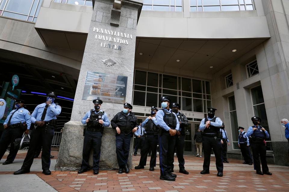 Police officers stand outside the Pennsylvania Convention Center where votes are being counted, Friday, Nov. 6, 2020, in Philadelphia.