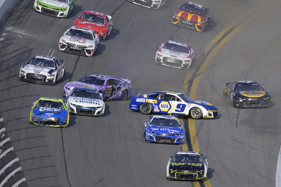 Daniel Suarez (99) and Chase Elliott (9) get caught up in a multi-car crash in Turn 4 during the NASCAR Daytona 500 auto race at Daytona International Speedway, Sunday, Feb. 19, 2023, in Daytona Beach, Fla. (AP Photo/Phelan M. Ebenhack)