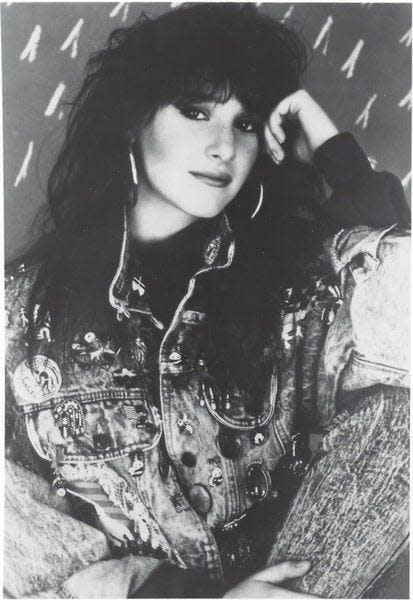 The singer Tiffany is shown in a black-and-white publicity photo from the 1980s.