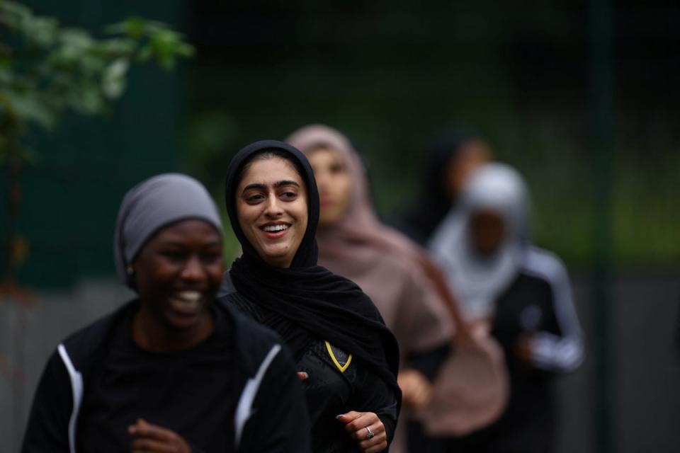 Fatima jogs around the pitch during warm up at a Sisterhood training session (Reuters)