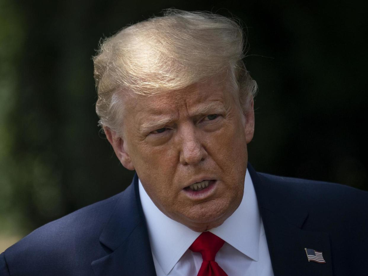 President Donald Trump speaks to reporters on the South Lawn of the White House before boarding Marine One on 15 July: (2020 Getty Images)