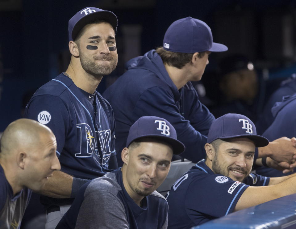 Tampa Bay Rays Kevin Kiermaier, top left, relaxes in the dugout with teammates in the fourth inning of a baseball game against the Toronto Blue Jays in Toronto Saturday Sept. 28, 2019. (Fred Thornhill/The Canadian Press via AP)