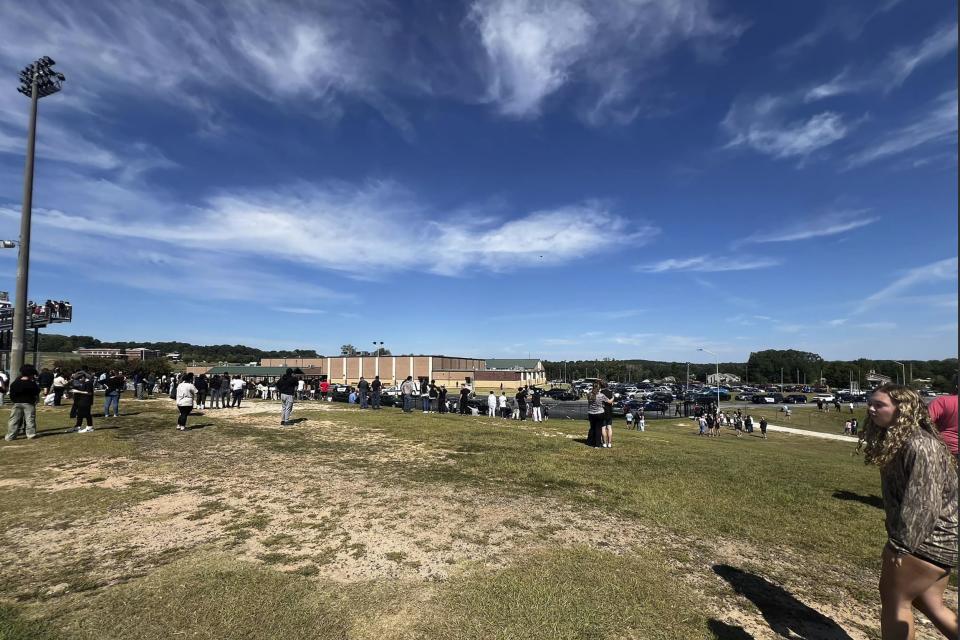 Students are evacuated to the football stadium after the school campus was placed on lockdown at Apalachee High School in Winder, Ga., on Wednesday, Sept. 4, 2024. (Erin Clark via AP)