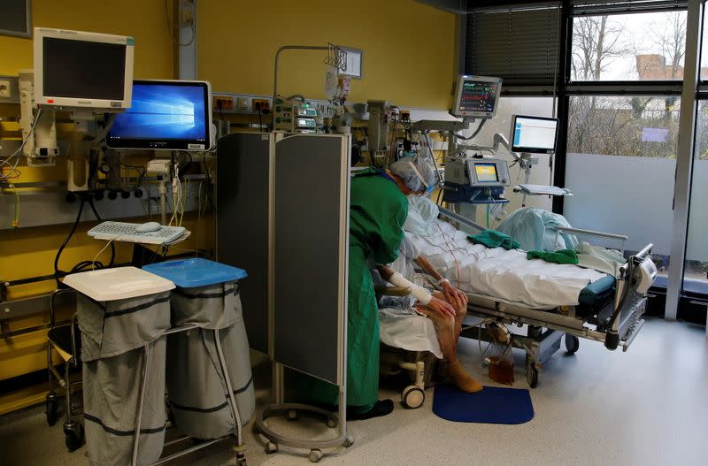 Medical workers in protective suits attend to coronavirus disease (COVID-19) patients at the intensive care unit (ICU) at the university hospital in Aachen