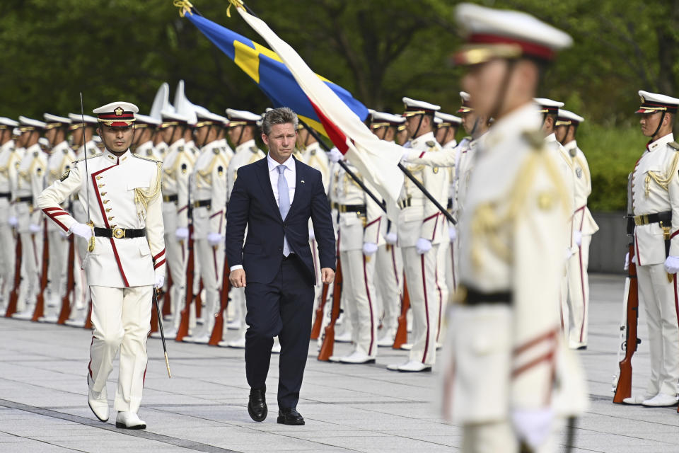 Sweden's Defense Minister Pal Jonson, center, reviews an honor guard, with Japan Defense Minister Yasukazu Hamada, not in photo, ahead their bilateral meeting at the Defense Ministry Wednesday, June 7, 2023, in Tokyo, Japan. (David Mareuil/Pool Photo via AP)
