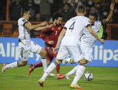 Armenia's Khoren Bayramyan, center, fights for the ball with Germany's Thilo Kehrer, right, Florian Neuhaus, left, and Matthias Ginter during the World Cup 2022 group J qualifying soccer match between Armenia and Germany at the Vazgen Sargsyan stadium in Yerevan, Armenia, Sunday, Nov. 14, 2021. (AP Photo/Hakob Berberyan)