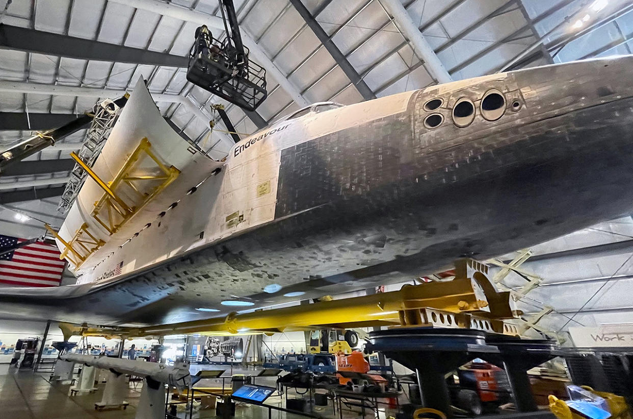  Crane operators work with former NASA contractors and a museum curator to carefully open space shuttle Endeavour's payload bay doors inside the Oschin Display Pavilion at the California Science Center in Los Angeles on Tuesday, Feb. 21, 2023. 