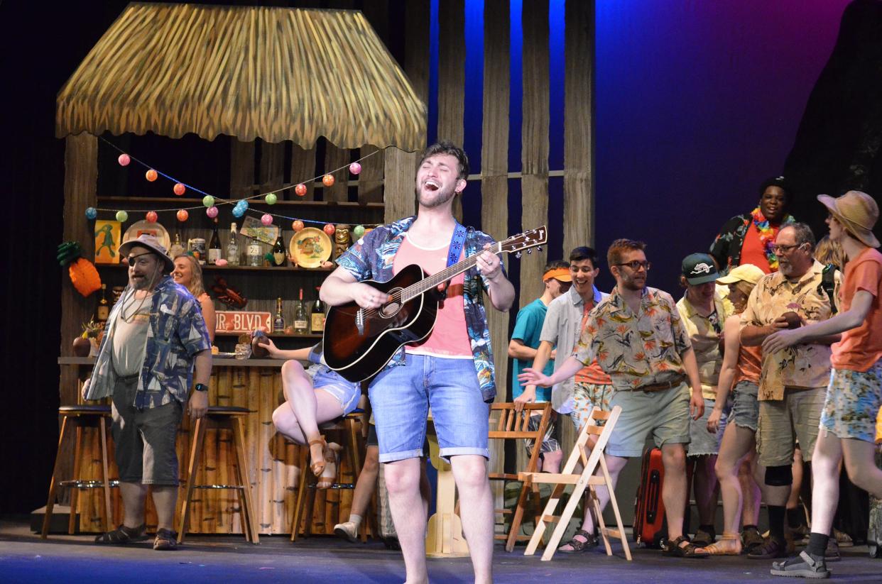 Maxwell Lam as Tully leads the Croswell Opera House's cast of “Escape to Margaritaville” in a song.