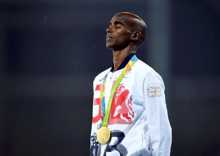 2016 Rio Olympics - Athletics - Victory Ceremony - Men's 5000m Victory Ceremony - Olympic Stadium - Rio de Janeiro, Brazil - 20/08/2016. Gold medalist Mo Farah (GBR) of Britain on the podium. REUTERS/Dylan Martinez