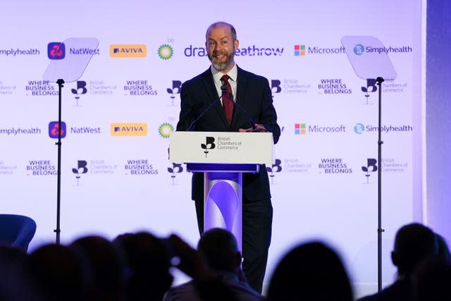 Jonathan Reynolds stands at a lectern and speaks to an audience