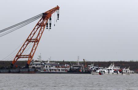 Rescue ships and a capsized ship are seen during a media trip to the site of the sinking, organized by the Chinese goverment, in the Jianli section of Yangtze River, Hubei province , China, June 3, 2015. REUTERS/Kim Kyung-Hoon