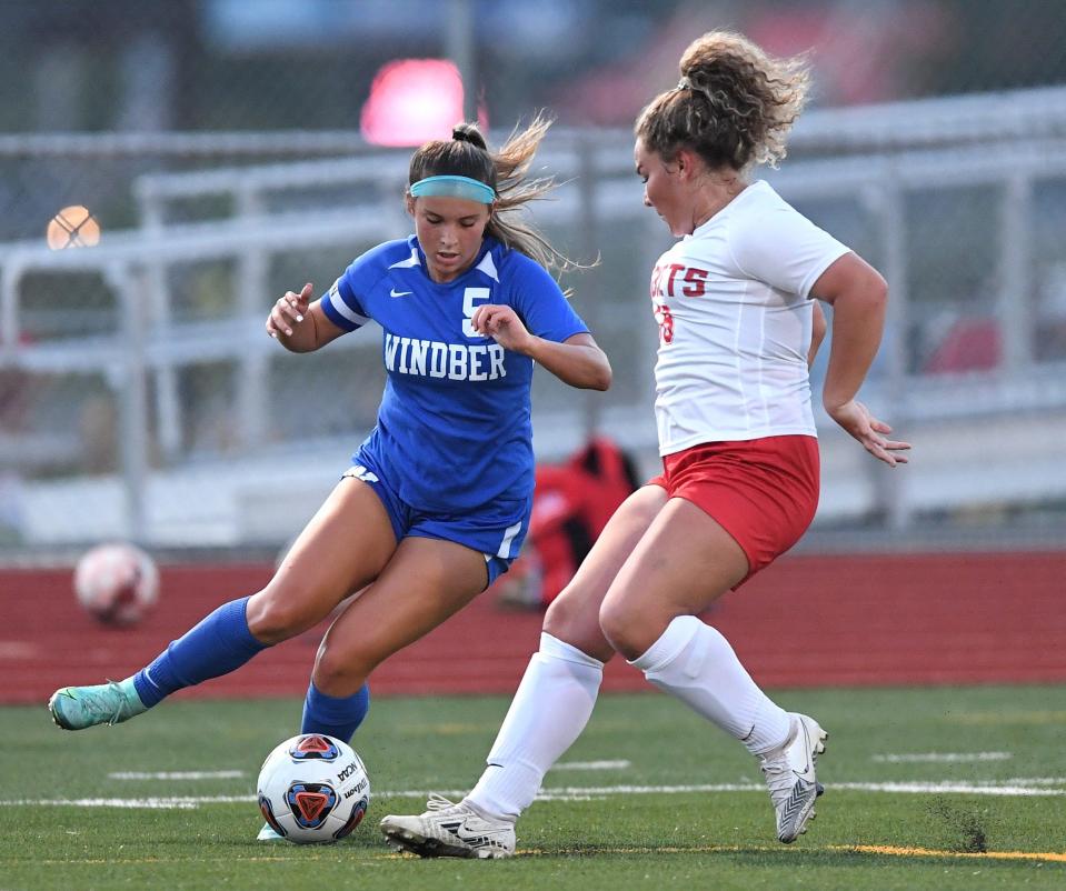 Windber's Anna Steinbeck, left, changes directions against Rockwood defender Shakhia Conn during a WestPAC girls soccer contest, Sept. 7, in Windber.