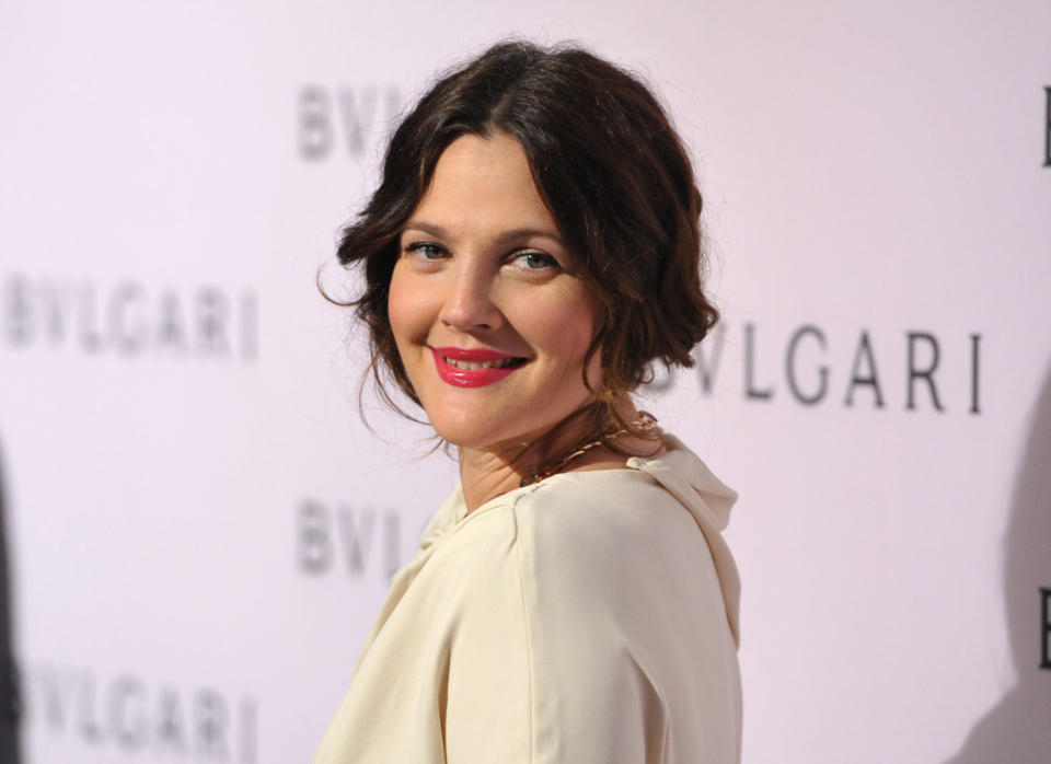 FILE - In this Feb. 19, 2013 file photo, Drew Barrymore arrives at BVLGARI's event celebrating Elizabeth Taylor and her magnificent BVLGARI jewel collection at BVLGARI Beverly Hills, in Beverly Hills, Calif. Fancy having Brad Pitt and Angelina Jolie, Barrymore and Dan Aykroyd over for dinner? You might start with an aperitif of Jolie and Pitt's new Miraval rose, move on to a light pasta dish served with Barrymore Wine's pinot grigio, then perhaps finish up with a glass of Canadian Aykroyd's cabernet franc ice wine for dessert. (Photo by John Shearer/Invision/AP, File)