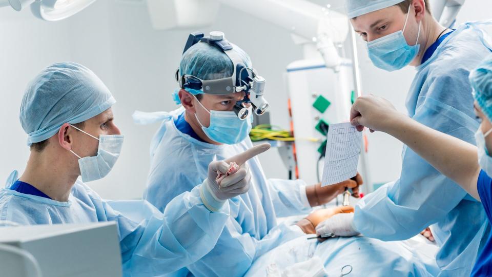 surgeon working on patient in operating room