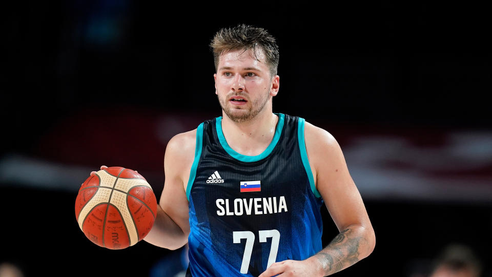 Slovenia's Luka Doncic drives up court during a men's basketball preliminary round game against Spain at the 2020 Summer Olympics, Sunday, Aug. 1, 2021, in Saitama, Japan. (AP Photo/Charlie Neibergall)