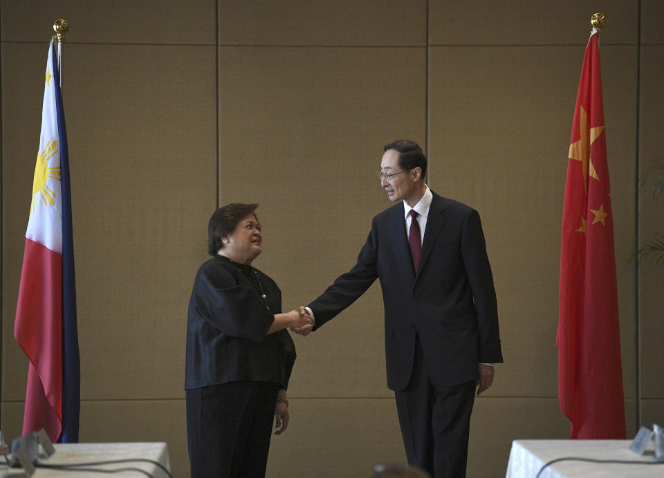 Theresa Lazaro, left, Philippines' Undersecretary for Bilateral Relations and Asian Affairs of the Department of Foreign Affairs, shake hands with Sun Weidong, China's Vice Foreign Minister, prior to the start of the Philippines-China Foreign Ministry consultation meeting at a hotel in Manila on Thursday, March 23, 2023.(Ted Aljibe/Pool via AP)