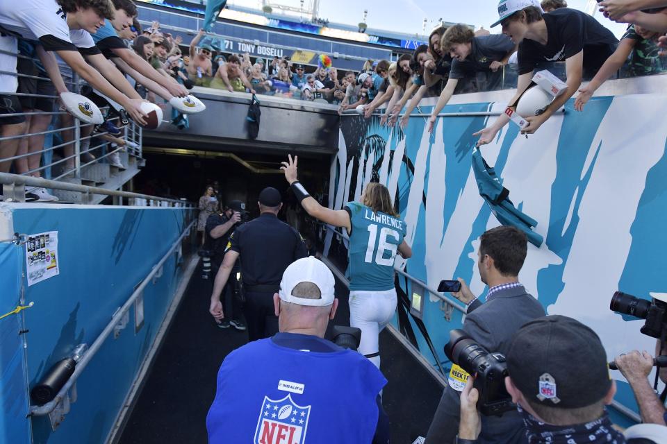 Jacksonville Jaguars quarterback Trevor Lawrence (16) waves to fans as he leaves the field following Sunday's season ending victory over the Colts. The Jacksonville Jaguars hosted the Indianapolis Colts at TIAA Bank Field in Jacksonville, Florida for the Jaguars final game of the season Sunday, January 9, 2022. The Jaguars finished out their season with a 26 to 11 victory over the Colts. [Bob Self/Florida Times-Union]