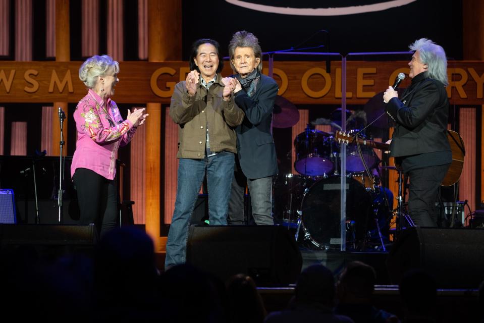 Connie Smith and Marty Stuart offer comedians Henry Cho and Gary Mule Deer inductions into the Grand Ole Opry during a special "Opry at the Ryman" show at the Ryman Auditorium